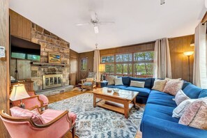 Relax in the spacious living room with plenty of comfy seating and a large TV - perfect for lounging and unwinding! Learn more about our guest experience at truenorthpocono.com!