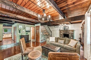 Modern rustic living area with convenient access to the downstairs bedroom, bathroom, laundry room, kitchen, and sunroom—designed for both comfort and ease.