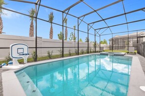 Dive into relaxation in your private screened pool oasis, complete with a fun basketball hoop and sun loungers.