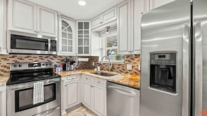 Fully equipped with modern appliances and plenty of counter space.