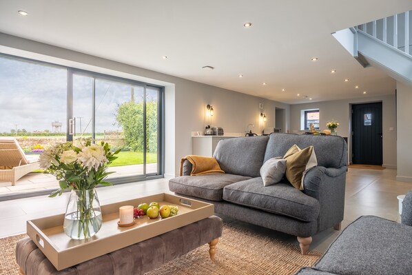 The Coach House (Happisburgh): The sitting room spills in to the lovely enclosed garden