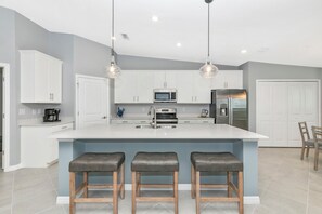 Large kitchen island and two pantries for plenty of storage