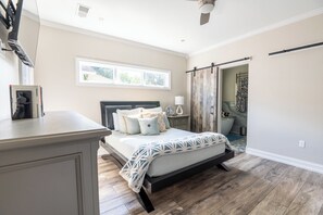 Cozy master bedroom with queen bed, sliding barn door to bathroom, and large master closet.