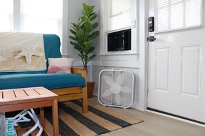 as you walk in, you are greeted by a full size queen futon couch, fan, a/c unit, and beautiful living room decorations