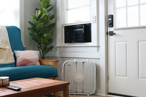 as you walk in, you are greeted by a full size queen futon couch, fan, a/c unit, and beautiful living room decorations
