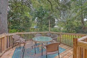 Relax on the private deck surrounded by lush greenery.