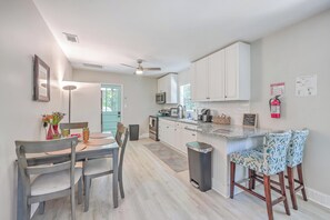 Bright dining space with a fully equipped, modern kitchen.