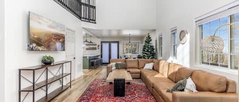 Living room with vaulted ceiling, open floor concept and massage chair.