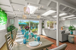 The Sunroom seats 10 for dining while gazing into the pollinator garden and yard