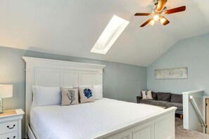 Spacious upstairs bedroom # 2 with a king bed and a cozy sofa.