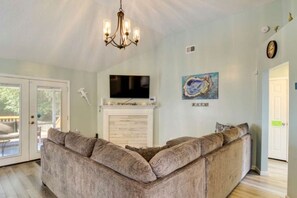 Inviting living room featuring a blend of modern design and beach-inspired decor, perfect for relaxation and entertaining.