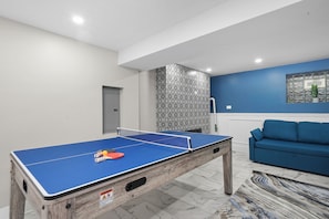 Basement Game Area with 75 Inch Samsung 4K TVs, Games, Sleeper Sofas, Fireplace