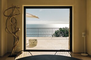 Glass wall offering a panoramic Adriatic Sea view and corten steel barrier.