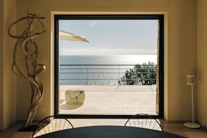 Glass wall offering a panoramic Adriatic Sea view and corten steel barrier.