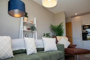 Three seater sofa, chair and footstool.