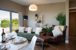 Dining table, sofa and arm chair with sea views