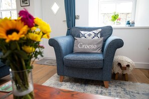 Lounge with armchair and coffee table with flowers