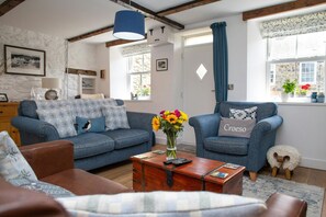 Lounge with two sofas, armchairs and wooden chest style coffee table