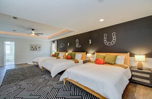 Bedroom with 3 queen beds and a ceiling fan