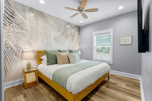 Guest Room #2 is stunning with a custom palm wall, new king bed, and 60in Smart TV