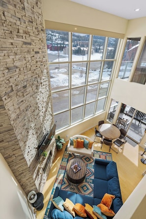 Awesome view from the second floor! You can see the bright living room and enjoy the stunning scenery through the big window | The Juniper, Brian Head, Utah | Voyax Luxury Vacation Rentals