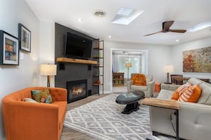 Living room with gas logs fireplace & 55" Smart TV (cable & YouTube TV available).