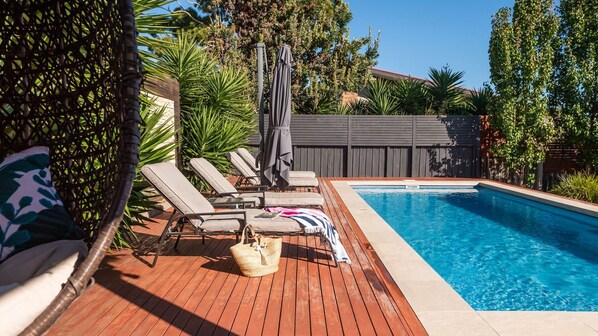Sunrise Oasis Sunlounges and Umbrellas by the Pool