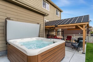 A large backyard with hot tub and patio