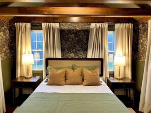 The green room features a queen sized bed with a premium brand mattress and linens. 