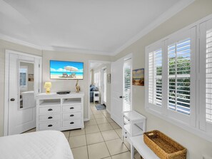 Primary bedroom off the living area with door to patio