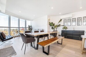 The bright, open-plan dining area offers a spacious, eight-seater table where you can share meals.
