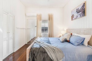 The primary bedroom features a king-sized bed and is air-conditioned to keep things comfortable.
