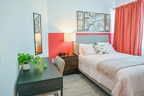 Relax and recharge in the cozy bedroom featuring a queen-sized bed and your own TV sanctuary.