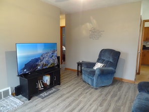 Living room with Roku TV, couch, and recliners