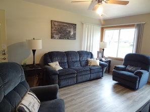 Living room with Roku TV, couch, and recliners