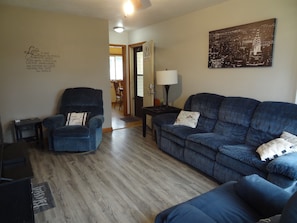 Living room with Roku TV, couch, and recliners