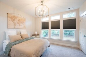 Master bedroom with natural sunlight and night stands