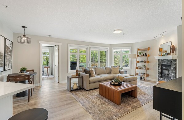Great room with view of balcony and into primary bedrooom