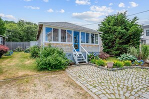 A whimsical blue front door and colorful plantings welcome you to Prestons Haven - 17 Captain Dunbar Road Brewster Cape Cod-Prestons Haven-NEVR