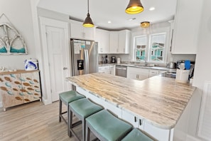 The well-appointed Kitchen boasts modern stainless appliances, ample counter space, and everything you need to whip up your favorite meals!