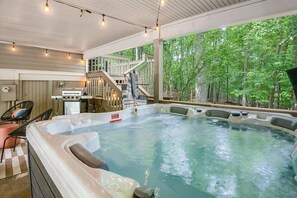 Soak in the hot tub while enjoying the serene natural surroundings