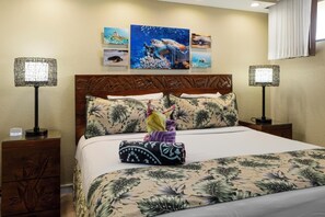 Retreat to this tranquil bedroom featuring a king-size bed, tropical-patterned bedding, and sea turtle artwork—blending comfort with island charm for a restful sleep.