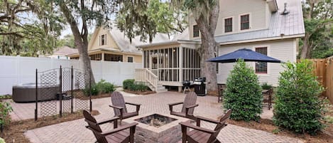 Large patio, hot tub, fire pit, gas and charcoal grills, outdoor dining table, screened porch = perfect backyard.