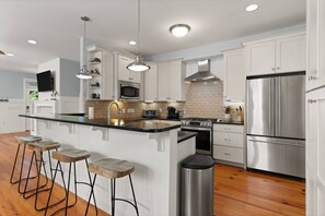 The large kitchen is stocked with all the cookware and utensils you'll need.