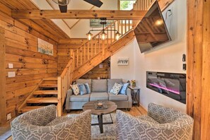 Den with couch, swivel chairs, electric fireplace & Smart TV
