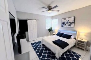 Bedroom 2: This spacious room offers a queen bed, TV, ceiling fan, and a private ensuite bathroom for added privacy.