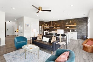 Relax in this spacious Living Area with a large Flat Screen TV and lots of brilliant, natural light.