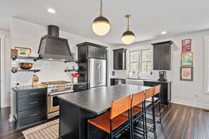 Impressive and well-equipped kitchen with gas range, dishwasher, and Keurig coffee maker