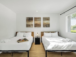 Primary Bedroom featuring 2 Queen Beds, a Smart TV and an ensuite primary bathroom.