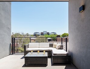 1st Floor: Private balcony off the living room offering outdoor furnishings for lounging.